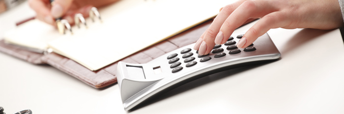 Hand using a calculator
