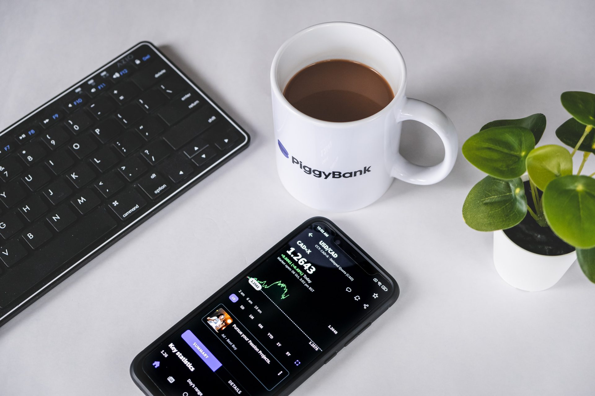 Coffee, phone and keyboard on a desk