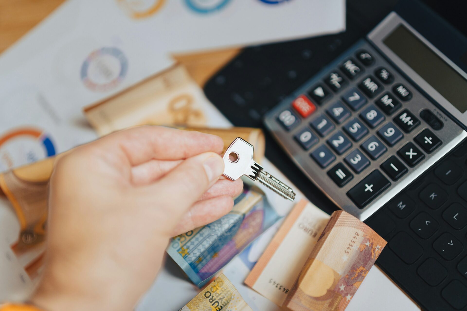 Handing over house keys over cash and a calculator